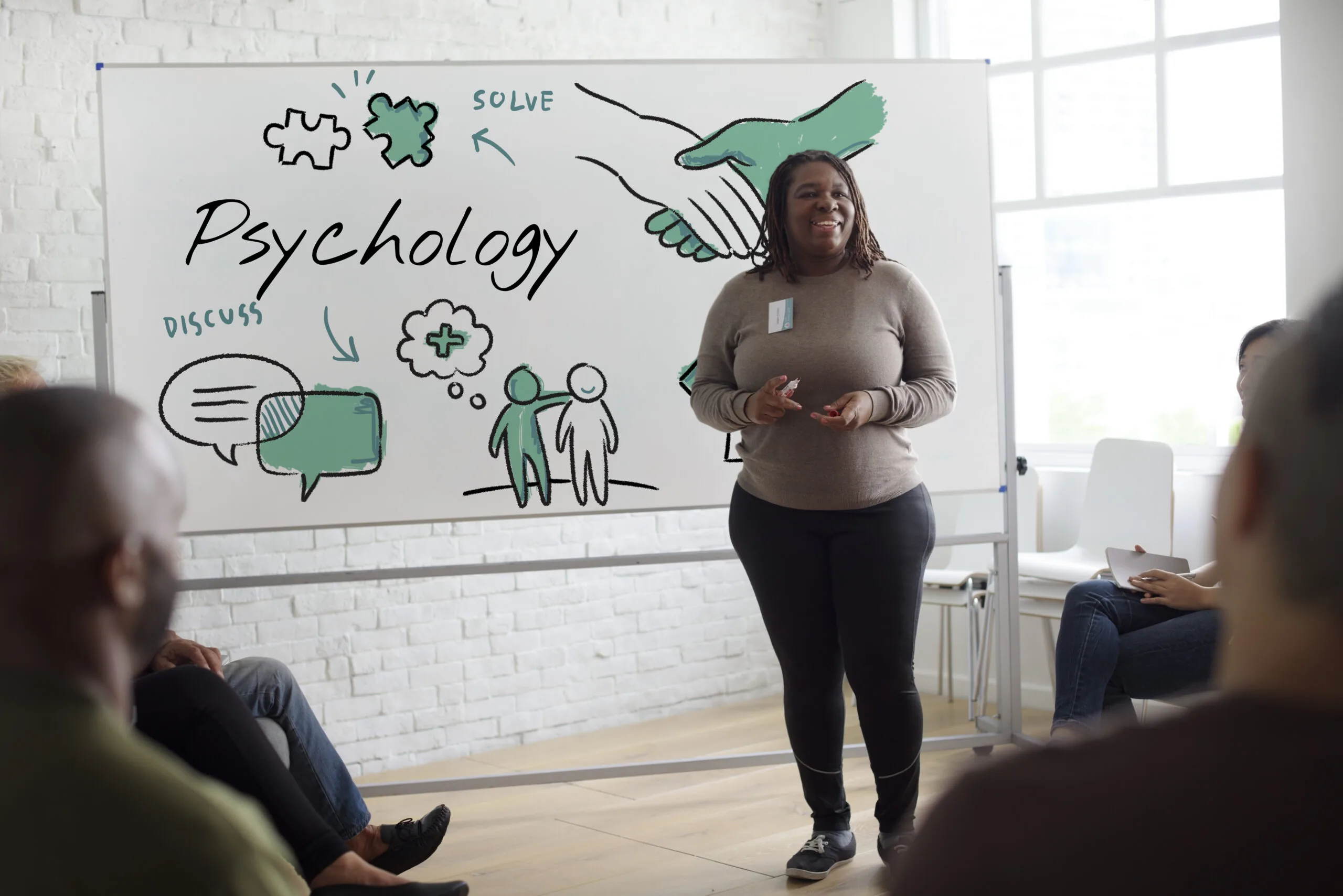 Mental health educator presenting psychology concepts to a group